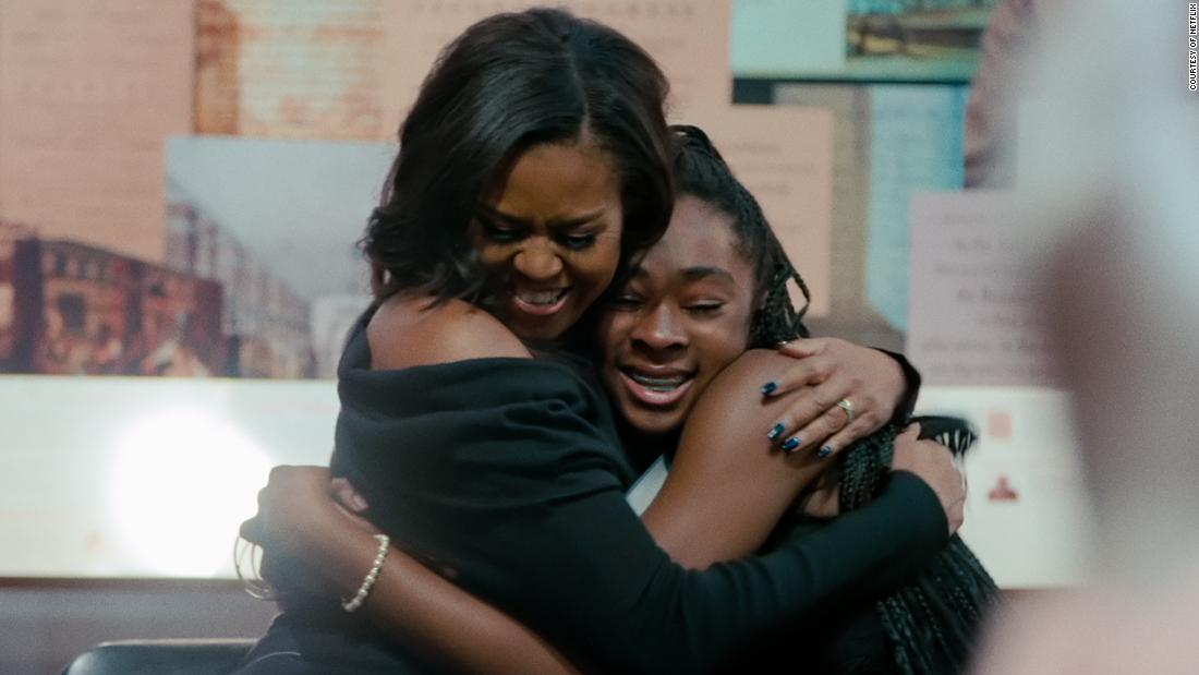 Obama shares a hug with a fan in her 2020 Netflix documentary &quot;Becoming,&quot; just one of the media projects she&#39;s been involved with this year. The Obamas signed a multi-year production deal with the streaming company in 2018, and in July 2020 the former first lady launched a podcast.