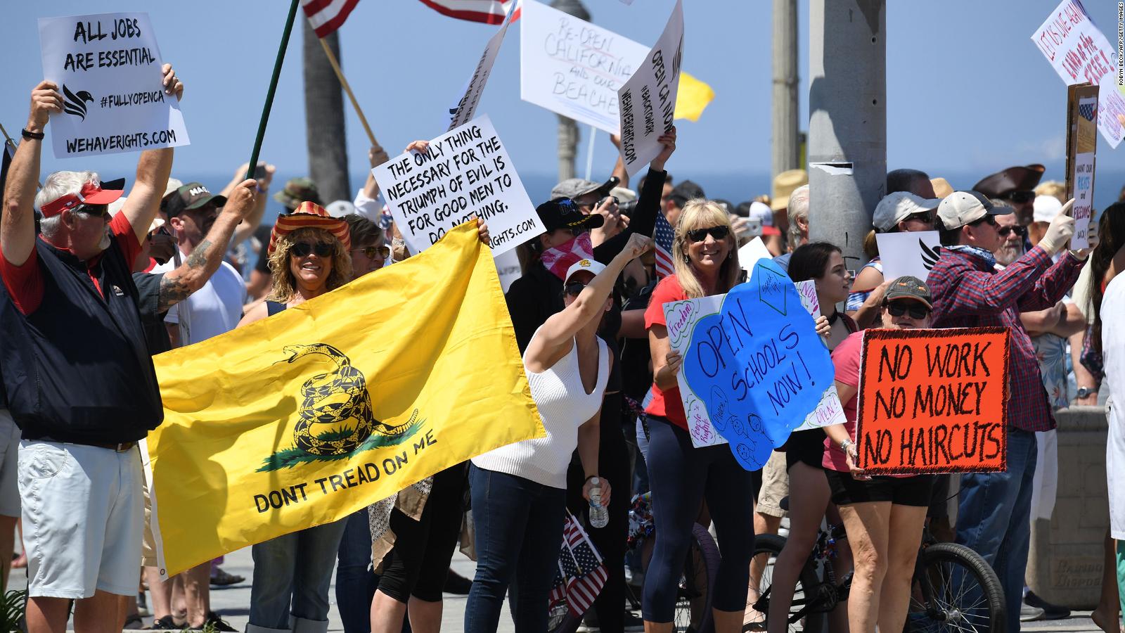 Large crowds in Huntington Beach protest beach closures by California