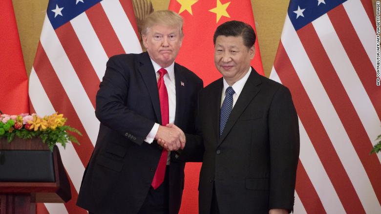 US President Donald Trump (L) shakes hands with China&#39;s President Xi Jinping during a press conference at the Great Hall of the People in Beijing on November 9, 2017. 