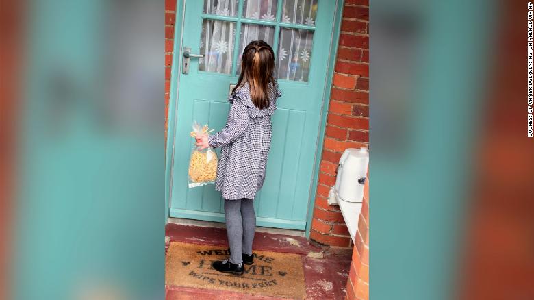 Princess Charlotte approaches a door with a bag of pasta. 