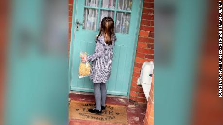 Princess Charlotte approaches a door with a bag of pasta. 