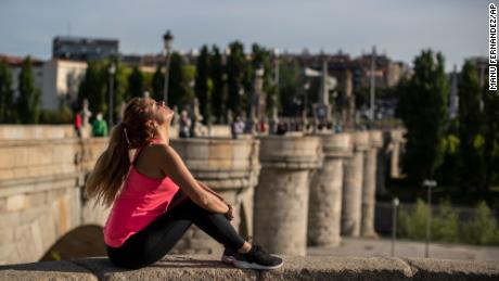 A woman basks in the sun at the Toledo bridge in Madrid, Spain, on Sunday, May 3.