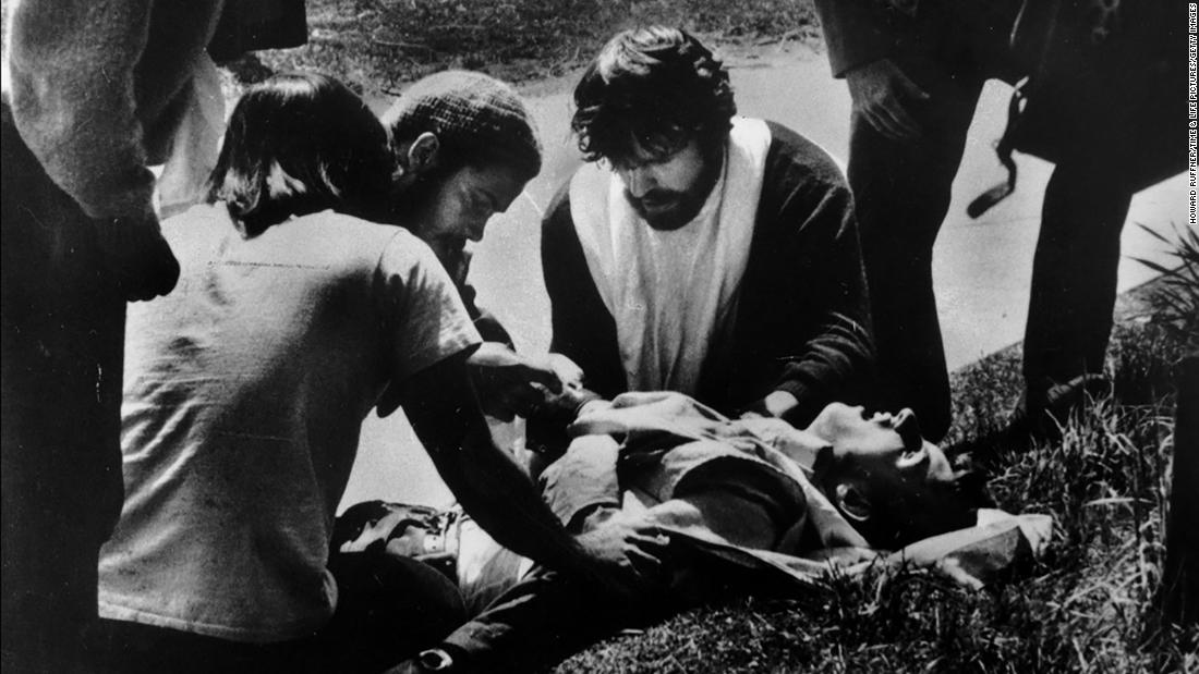 Kent State students gather around a wounded student.
