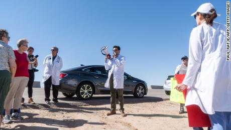 Dr. Pritesh Gandhi addresses doctors, nurses and medical students gathered at the Tornillo Port of Entry on in June 2018 in Tornillo, Texas, to demand an end to separation of immigrant children from their parents. He&#39;s one of many medical professionals running for elected office this cycle on a platform of in part defending science. 