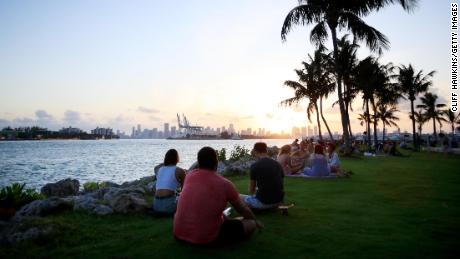 People gather for sunset in South Pointe Park on April 29, 2020 in Miami Beach, Florida.