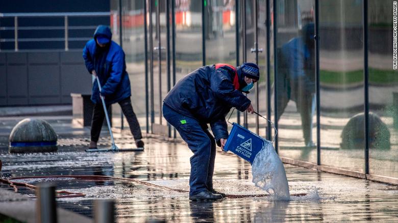 Workers clean a street in central Moscow on May 2.