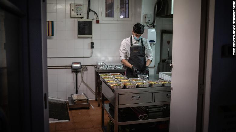 A cook works in Barcelona, Spain on April 16 after his restaurant's kitchen was converted to prepare food for health personnel and vulnerable people.