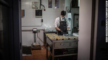 A cook works in Barcelona, Spain on April 16 after his restaurant&#39;s kitchen was converted to prepare food for health personnel and vulnerable people.