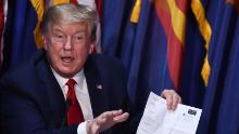 US President Donald Trump holds up a sheet with COVID-19 statistics as he takes part in a roundtable on supporting Native Americans and participates in a tour of a Honeywell International plant that manufactures personal protective equipment in Phoenix, Arizona on May 5, 2020. (Photo by Brendan Smialowski / AFP) (Photo by BRENDAN SMIALOWSKI/AFP via Getty Images)