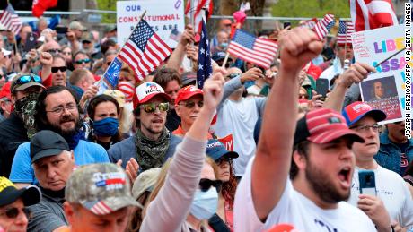 Protesters in Boston rally on May 4 against stay-at-home orders and a law requiring everyone to wear a mask in public. 