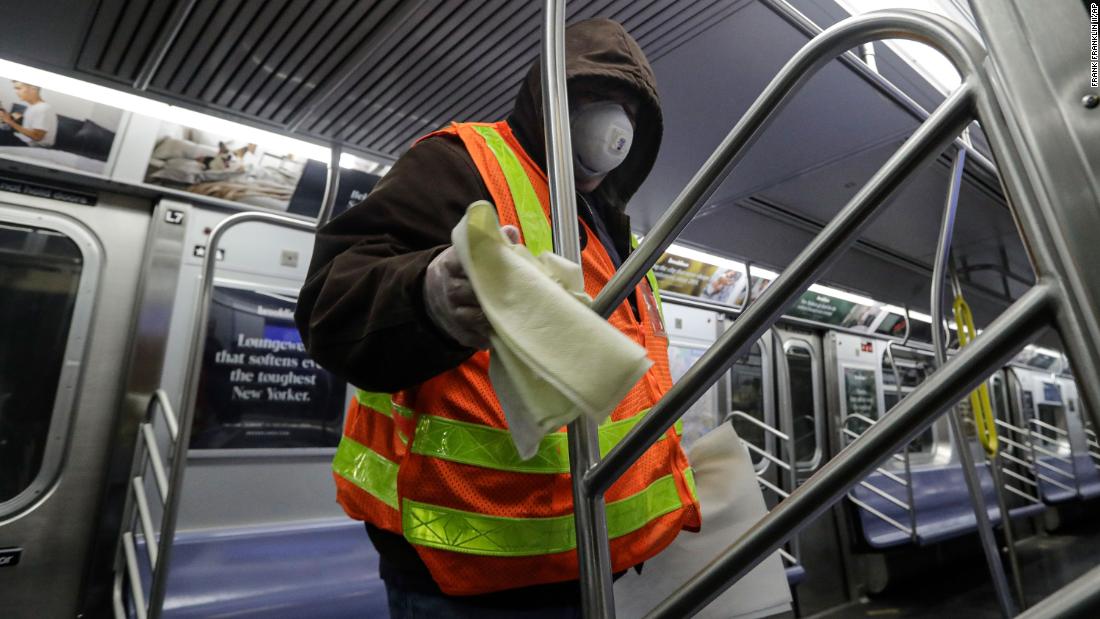 A worker helps disinfect a subway train in New York on May 6, 2020. The subway syatem was shut down for a deep-cleaning.