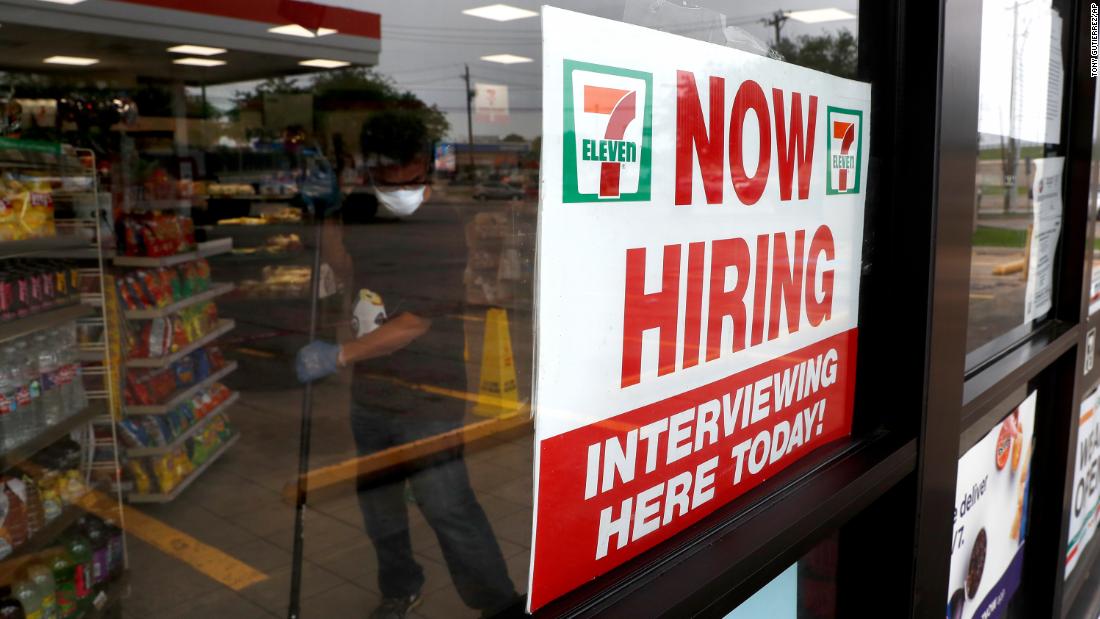 A sign at a 7-Eleven store in Dallas reads &quot;Now Hiring&quot; as an employee inside the store mops the floor in April.