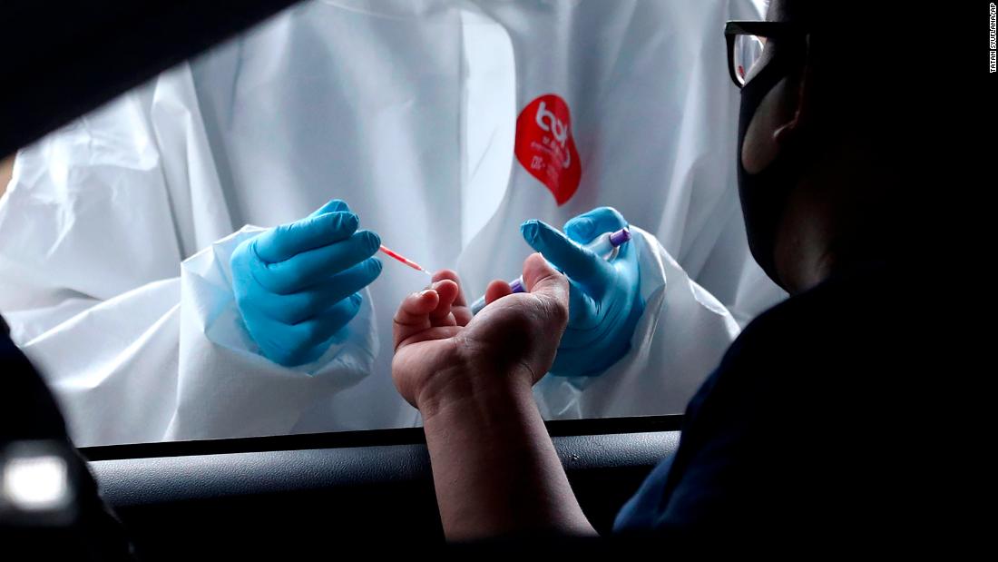 A health worker collects a man&#39;s blood sample for a coronavirus antibody test in Tangerang, Indonesia, on May 4.