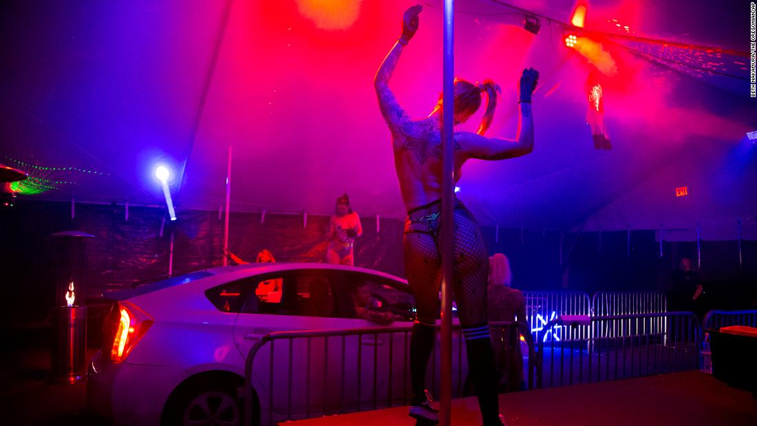 Go-go dancers perform in the Lucky Devil Lounge parking lot while customers wait in their cars in Portland, Oregon, on April 17. &quot;After first offering food delivery, the Lucky Devil Lounge has started a second creative venture: food pickup via a drive-thru strip club,&quot; &lt;a href=&quot;https://www.oregonlive.com/living/2020/04/a-drive-thru-strip-club-movie-popcorn-to-go-oregon-businesses-get-creative-during-coronavirus.html&quot; target=&quot;_blank&quot;&gt;wrote Samantha Swindler of The Oregonian/OregonLive.&lt;/a&gt; &quot;Four dancers, in short shorts and pasties, perform under cover of an outdoor tent in the club parking lot, while customers wait for their orders in their cars.&quot;