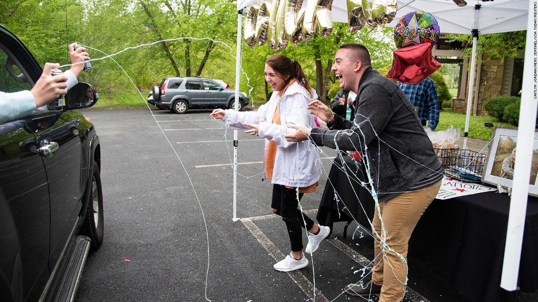 Twins Abby and Austin Angel get sprayed with Silly String at &lt;a href=&quot;https://www.knoxnews.com/story/life/2020/04/27/class-2020-knoxville-family-hosts-drive-through-graduation-party-after-coronavirus-cancels-ceremony/3030545001/&quot; target=&quot;_blank&quot;&gt;their drive-thru graduation party&lt;/a&gt; in Knoxville, Tennessee, on April 26. They had just graduated from high school.