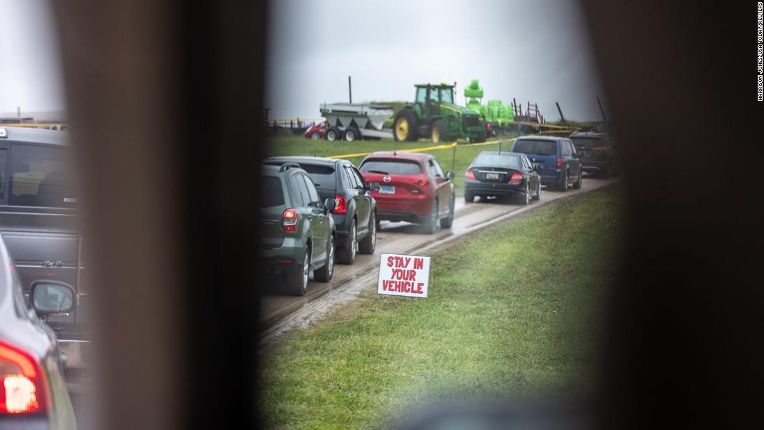 A &quot;stay in your vehicle&quot; sign is pictured in Fawn Township, Pennsylvania, as cars line up for the &lt;a href=&quot;https://www.eveningsun.com/picture-gallery/news/2020/04/27/photos-maple-lawn-farms-fawn-township-pa-drive-through-strawberry-festival/3034369001/&quot; target=&quot;_blank&quot;&gt;Maple Lawn Farms drive-thru strawberry festival&lt;/a&gt; on April 26.