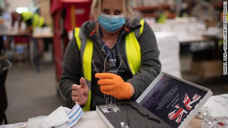 Workers preparing commemorate figures for VE Day are wearing protective equipment against coronavirus.