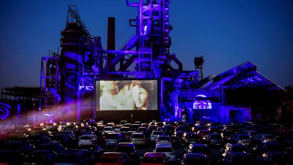 Cars sit at a newly opened drive-in cinema in Dortmund, Germany, on April 17. It's in front of a former blast furnace.