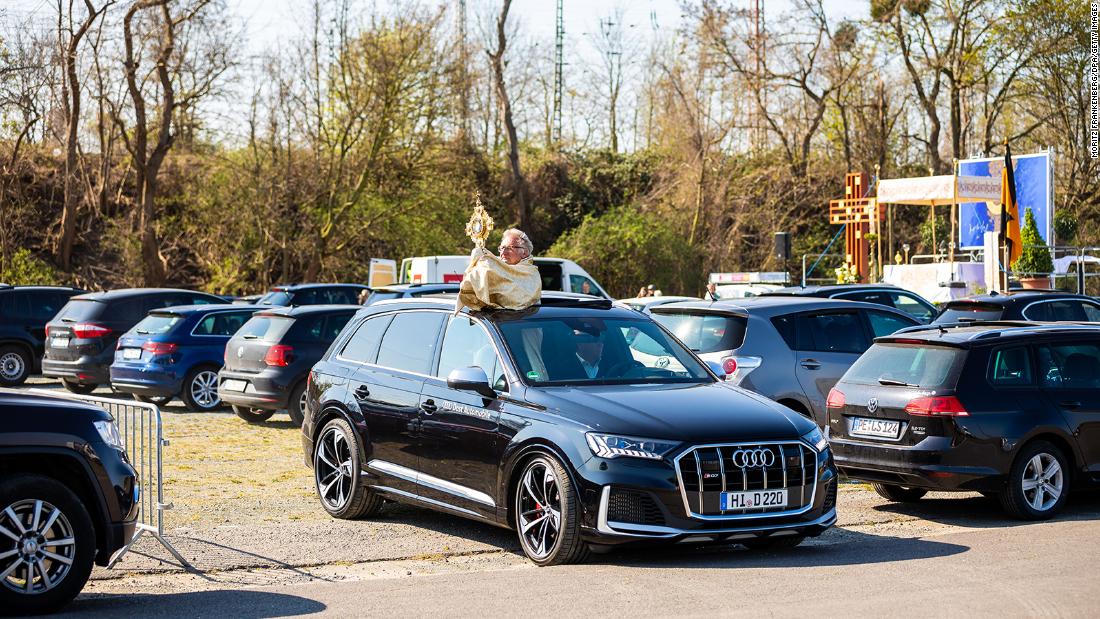 Pastor Hans-Günter Sorge holds the monstrance during a drive-in Easter service in Hildesheim, Germany, on April 12.