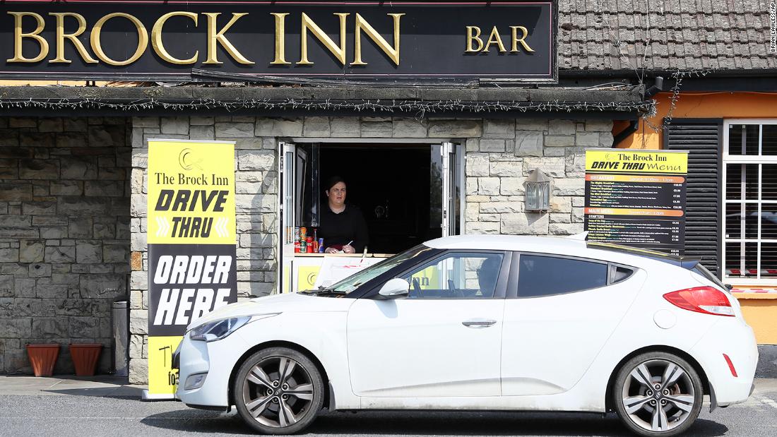 Staff member Lauren Byrne takes orders at The Brock Inn in County Dublin, Ireland, on April 25. The inn set up a drive-thru service to provide breakfast, lunch and dinner.
