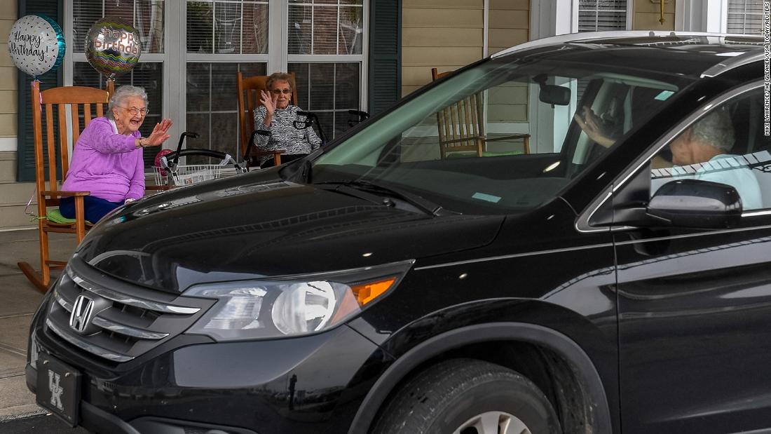 Pauline Thompson, left, waves to a passing car during &lt;a href=&quot;https://www.thegleaner.com/story/news/2020/03/31/nursing-homes-go-extra-mile-keep-residents-linked-during-covid-19/2918091001/&quot; target=&quot;_blank&quot;&gt;her drive-thru birthday party&lt;/a&gt; in Henderson, Kentucky, on March 27. Thompson, a resident at the Colonial Assisted Living facility, was turning 97, and she had a drive-thru party because she was unable to celebrate with family and friends.