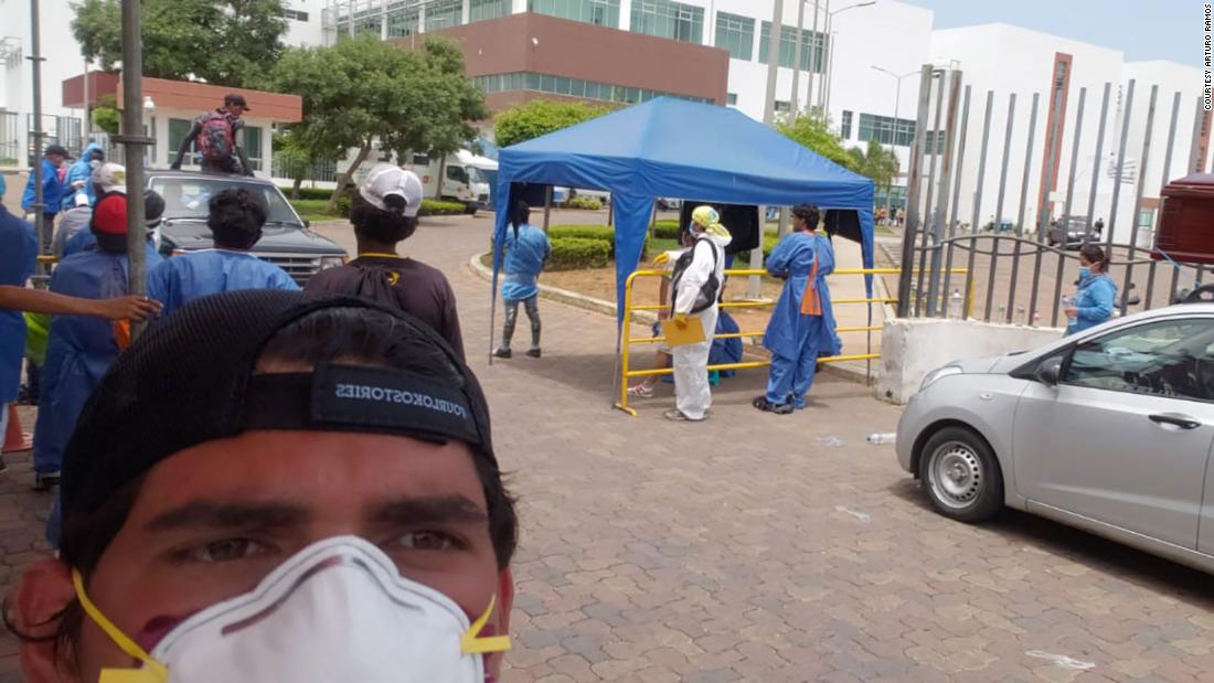 Arturo Ramos, 24, on day 3 of looking through bodies in the hospital morgue and containers for his father. To the right, vehicles in line with coffins as they await to pick up the remains of their loved ones.