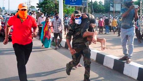 Rescuers evacuate people following a gas leak incident at an LG Polymers plant in Visakhapatnam on May 7.