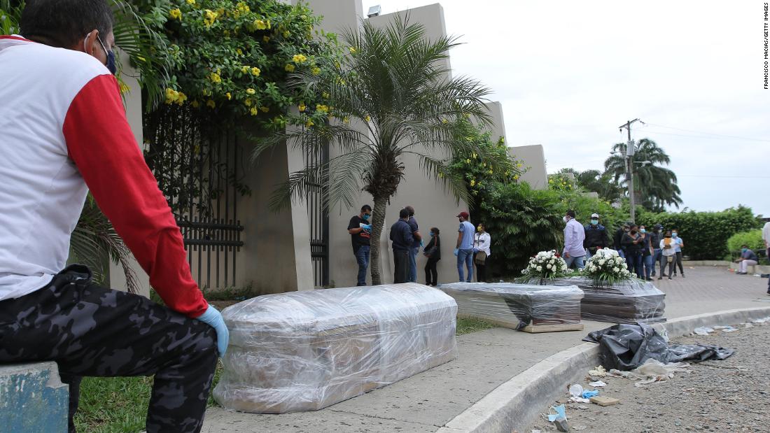 Relatives of the deceased line up for a funeral outside the Durán Cemetery in Guayaquil, Ecuador, on April 5.