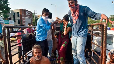 People affected by the gas leak are carried out of a truck to an ambulance in Vishakhapatnam.