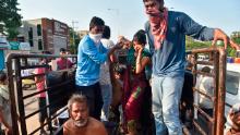 People affected by the gas leak are carried out of a truck to an ambulance in Vishakhapatnam.