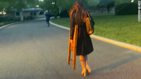 OAN correspondent Chanel Rion seen carrying a chair on White House grounds