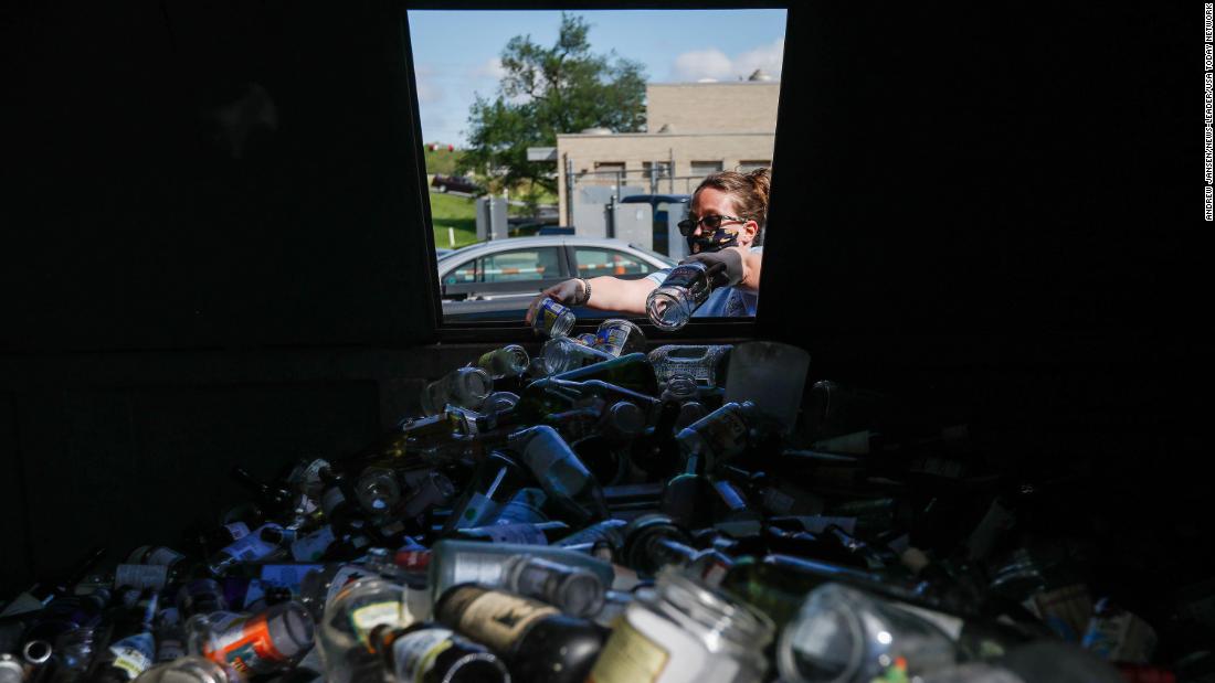 Kelly Watson puts glass in a recycling bin in Springfield, Missouri, on May 6, The Lone Pine Recycling Center had just reopened.