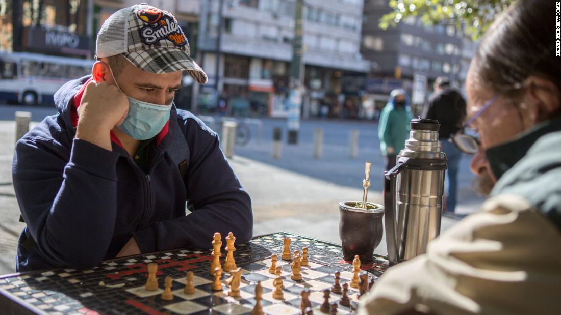 Two men wearing face masks play chess in Montevideo, Uruguay, on May 7.