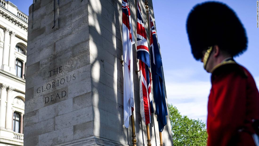 A member of the British Armed Forces stands next to The Cenotaph war memorial in London.