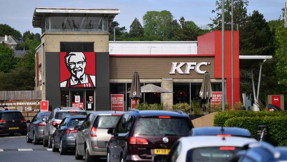 A long line of cars forms as a KFC drive-thru reopens in Plymouth, England, on May 8.