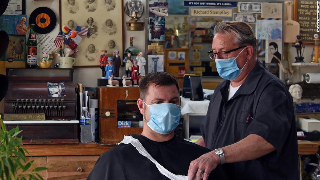 A man receives a haircut at Doug&#39;s Barber Shop in Houston on May 8.