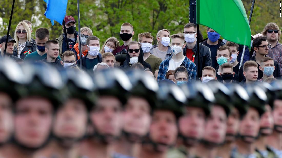 People wear face masks while watching a Victory Day military parade in Minsk, Belarus, on May 9, 2020. The parade marked the 75th anniversary of the Allied victory over Nazi Germany in World War II.