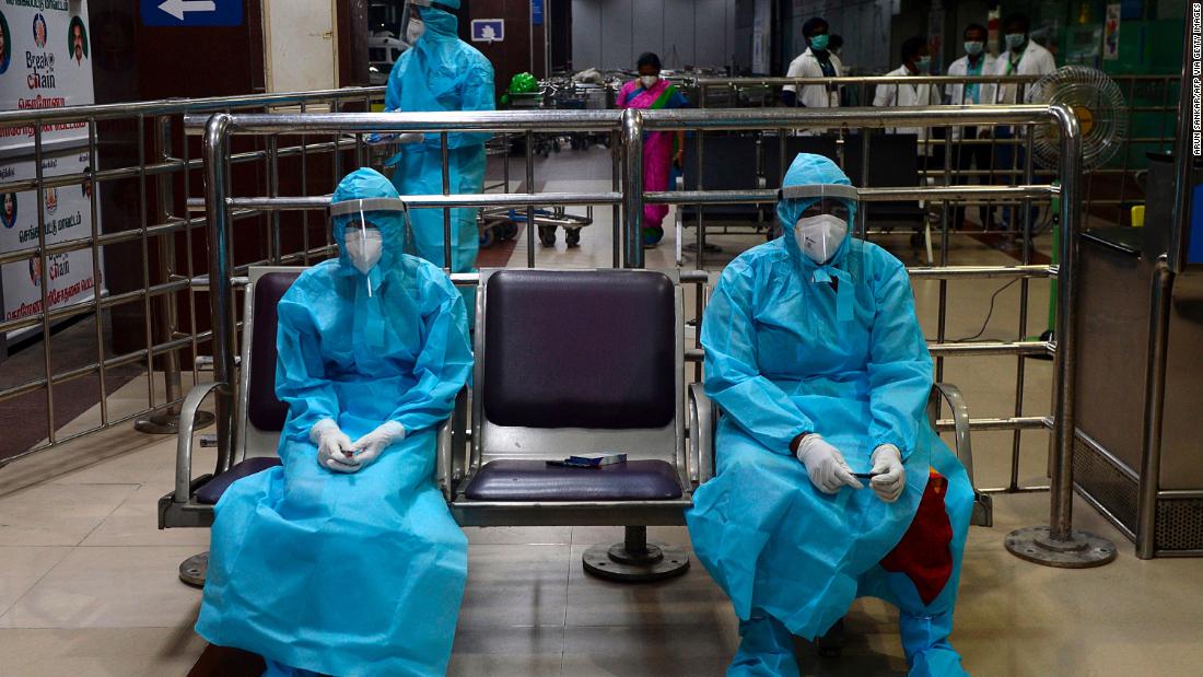 Health-care workers wait for citizens to arrive at the Anna International Airport in Chennai, India. People were arriving in Chennai from Dubai, United Arab Emirates.