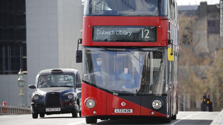 A London bus driver wears a face mask as a precautionary measure against Covid-19.