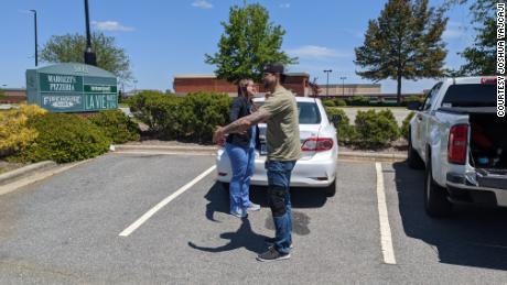 The siblings share a socially distanced hug outside the hospital in North Carolina. 
