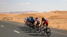 A breakaway group led by Team Novo Nordisk&#39;s Charles Planet races during the Tour of Dubai in 2016. 