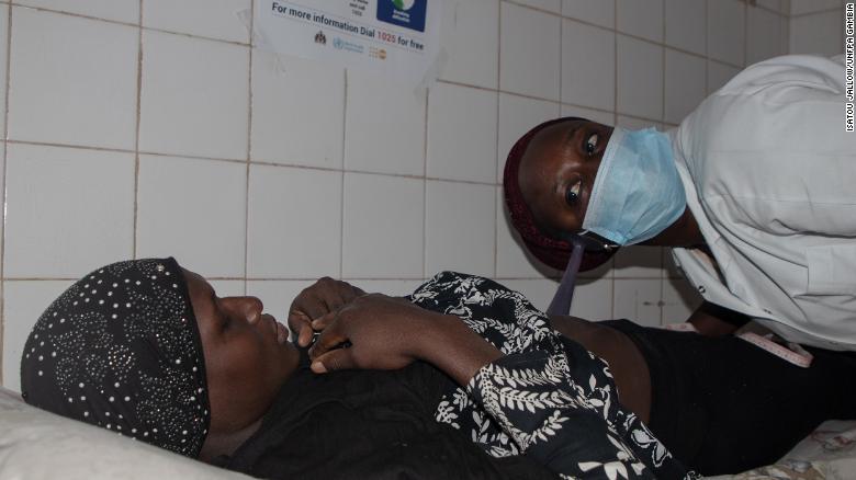 Midwife Fatou Joof examines a woman  at the Serrekunda Health Centre.