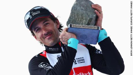 Cancellara celebrates on the podium following the 2013 Paris-Roubaix cycle race.