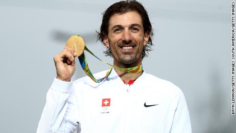 Cancellara poses with one of his two gold medals at the Rio 2016 Olympic Games.