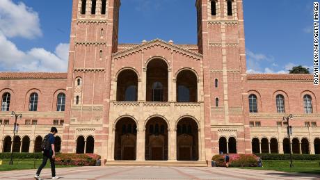 A student walks toward Royce Hall on the campus of University of California at Los Angeles (UCLA) in Los Angeles, California on March 11, 2020. 