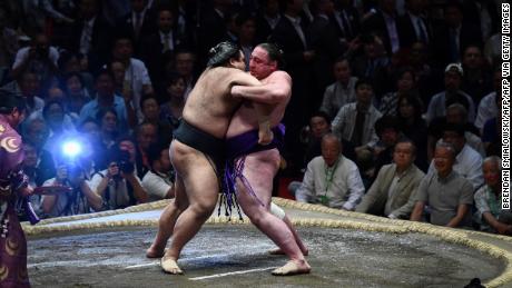 Sumo wrestler Tochinoshin of Georgia (right) battles Takayasu of Japan (left) during the Summer Grand Sumo Tournament in Tokyo on May 26, 2019. 