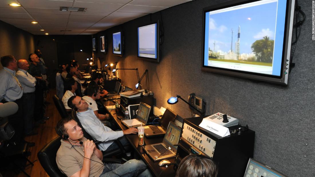 Musk, bottom, watches a Falcon 1 rocket lift off in 2008. It was the first privately developed liquid-fuel rocket to reach orbit.