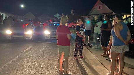 Neighbors talk to police after a group harassed a black family at its Pender County home May 3.