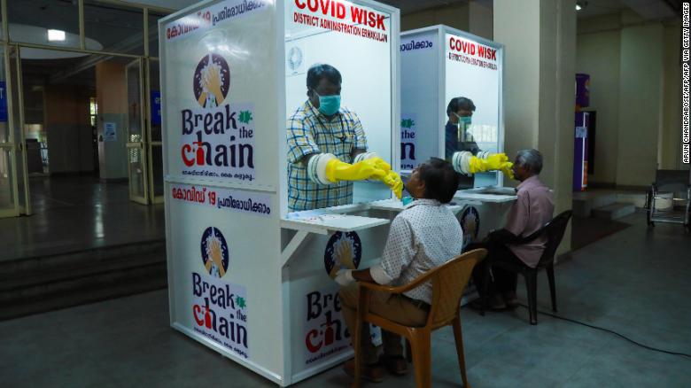 Medical staff collect samples from people at a kiosk to test for Covid-19 in Kerala, India, on April 6, 2020. 