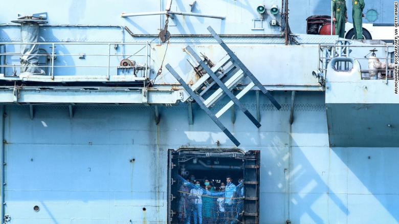 Indian citizens evacuated from Maldives look outside the Indian Navy INS Jalashwa ship as it arrives to Cochin port in Kochi on May 10, 2020.